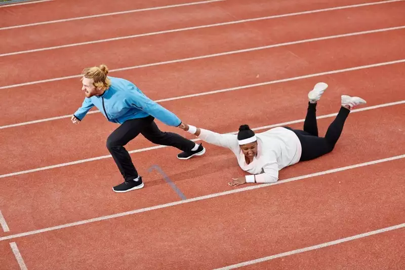Personal trainer dragging client on floor on a racetrack. Bad personal trainer concept. 