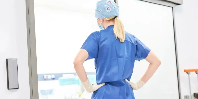 Female Nurse Looking Into Surgery