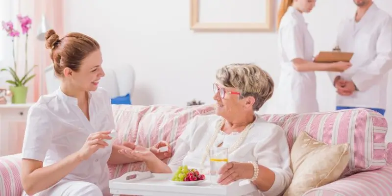 Private Nurse Talking To Elderly Patient