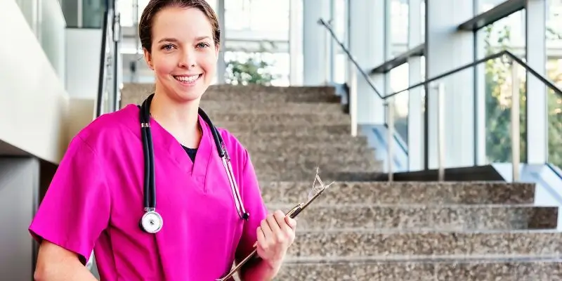 Private Nurse In Pink Uniform Smiling At The Camera