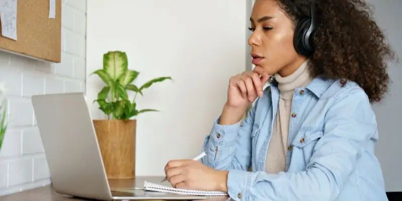 Woman Studying At Home On Laptop