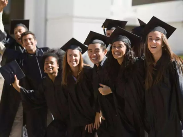 university students in robes looking at camera