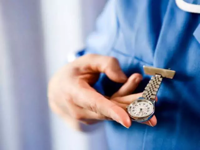 nurse looking at pocket watch