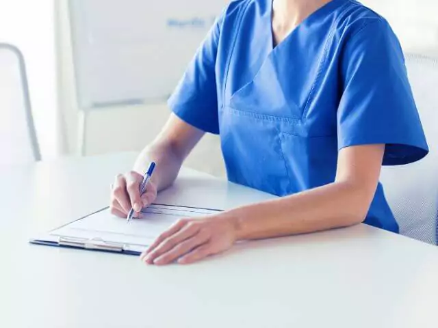 nurse writing on notepad