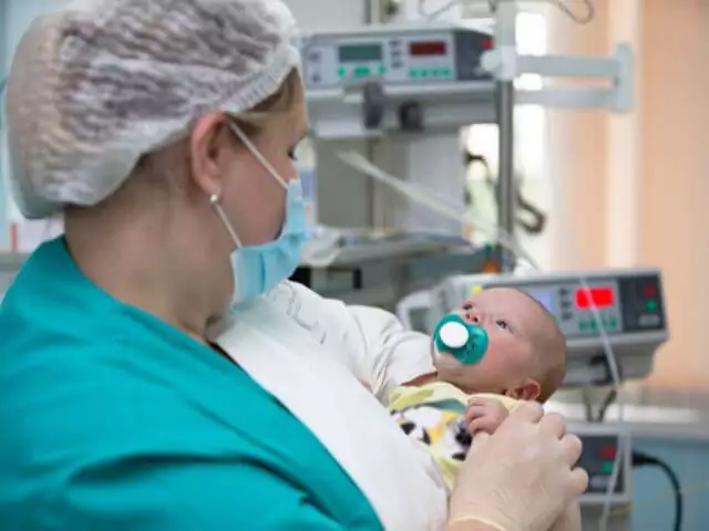 neonatal nurse holding baby