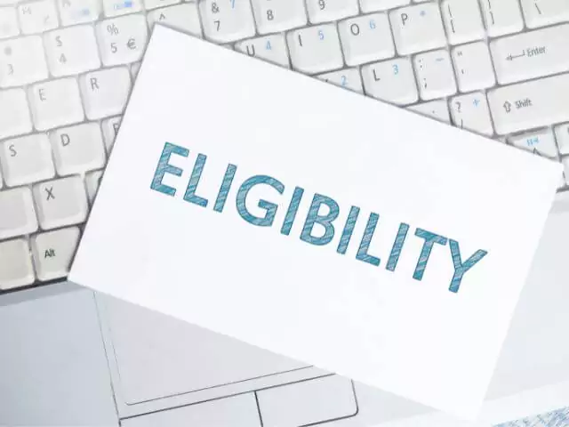 eligibility written on paper sat on top of laptop