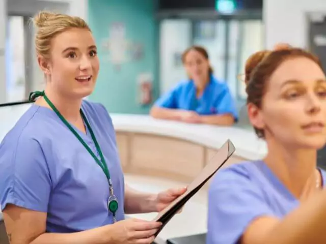 nurses discussing medical notes