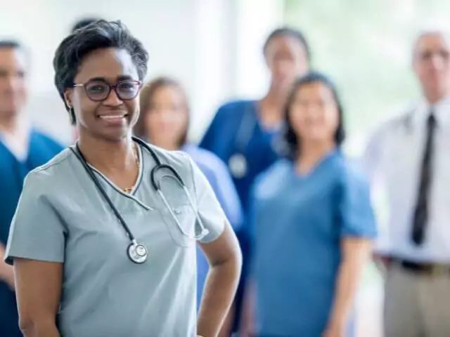 nurses stood looking at camera