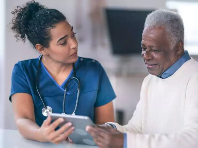 nurse talking to elderly patient