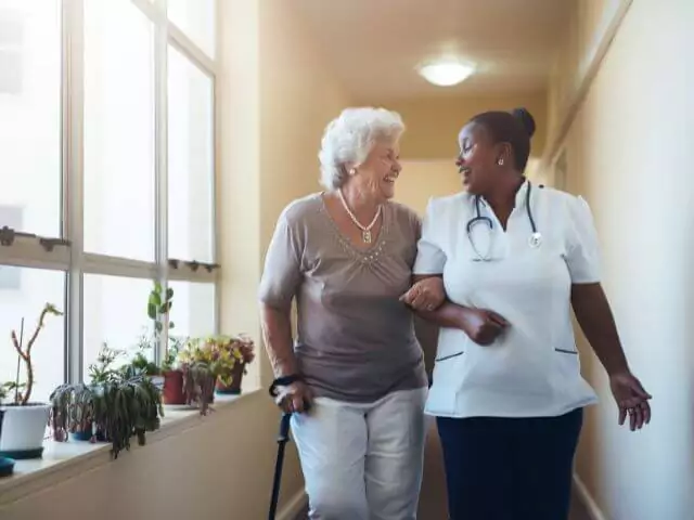 nurse walking paitent home in care home