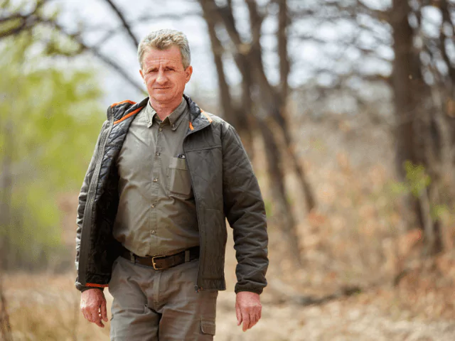 Park Ranger Standing In A Forest