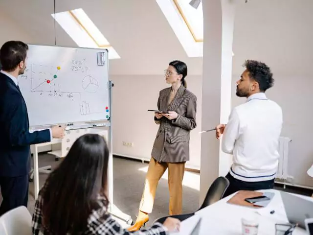 people working planning on a whiteboard