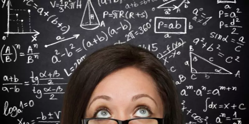 womans head surrounded by maths symbols written in chalkboard