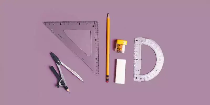 maths tools laid out on pink desk