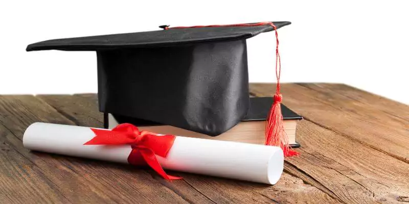 university scroll and cap sitting on desk