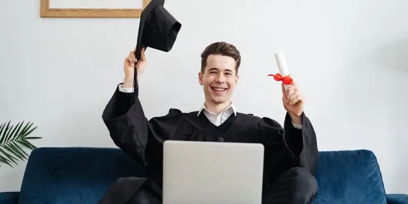 man celebrating getting degree online