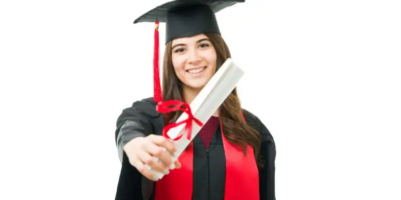 woman holding degree certificate dressed in robes