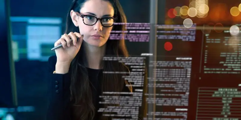 woman looking at code on digital screen