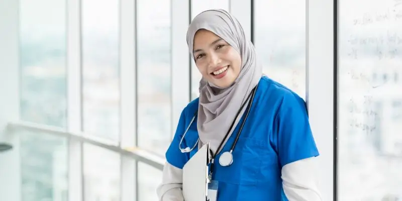 nurse standing in hospital looking at the camera