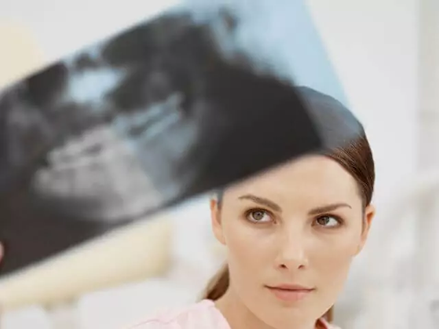 dental nurse looking at xray of teeth