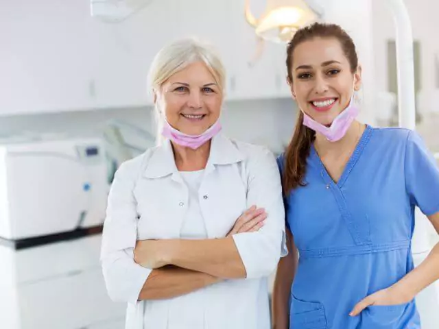 dentist and dental nurse smiling