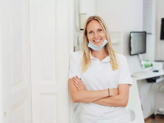 dental nurse standing in surgery looking at camera