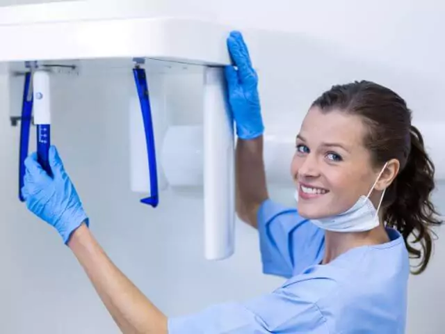 dental nurse setting up xray machine