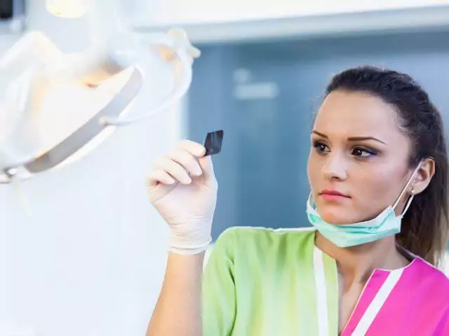 dental nurse looking at x-ray