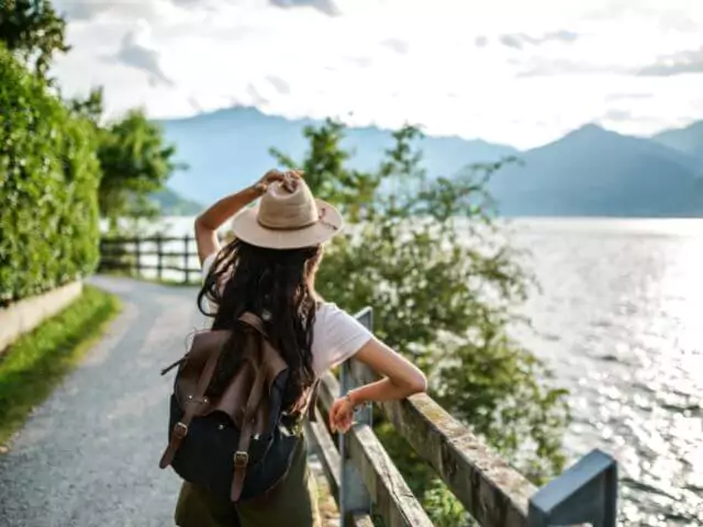 woman travelling looking at lake