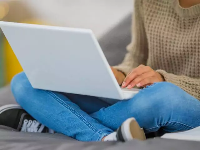 woman sitting on the floor studying on laptop