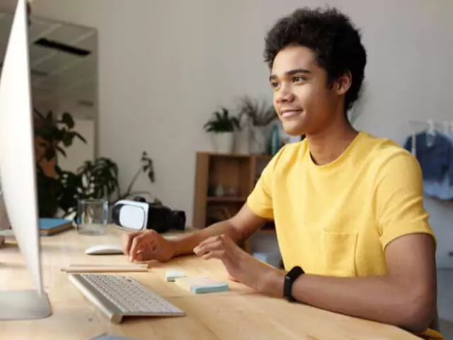 man studying at mac sat at desk