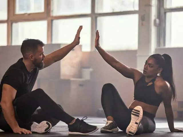 personal trainer high fiving student