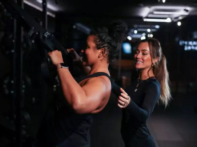 female personal trainer coaching student