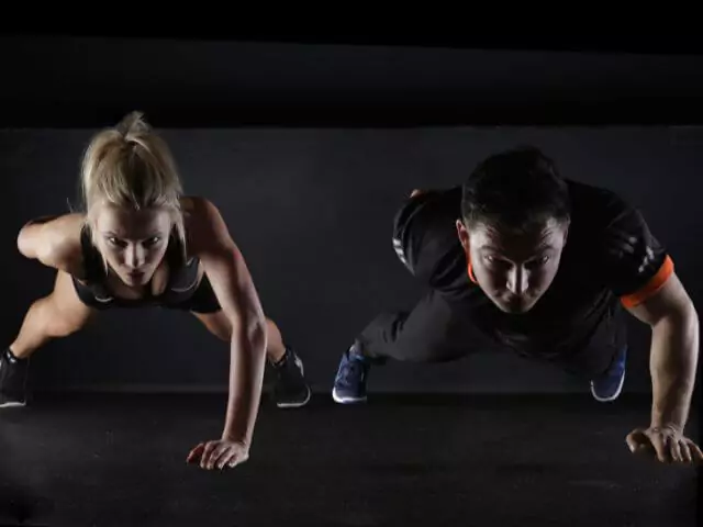 woman and man doing push ups