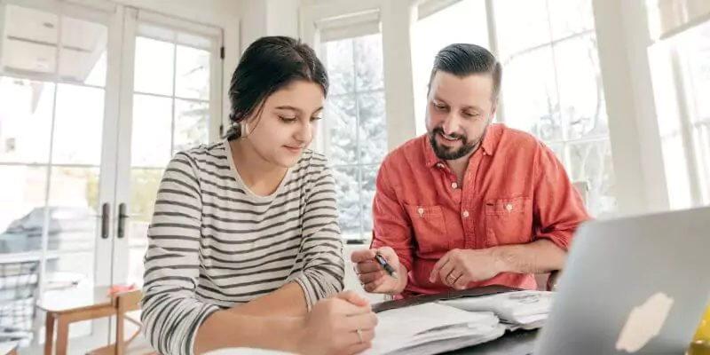 father helping daughter study