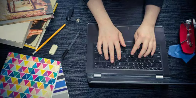 student working on laptop at desk