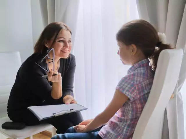 female social worker talking to child