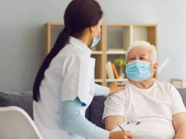 carer talking to elderly man