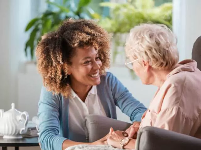 carer talking to elderly woman