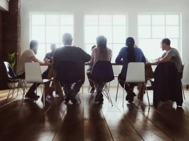 Group Of People Talking Around Table