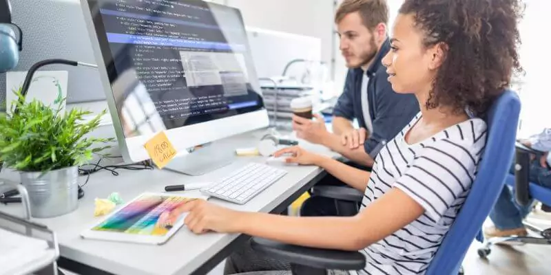 Group of web developers working on a project in a modern office.