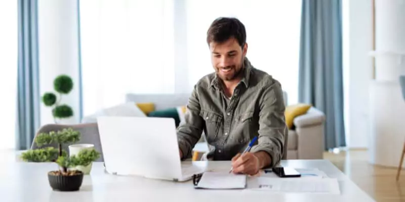 man studying online course on laptop