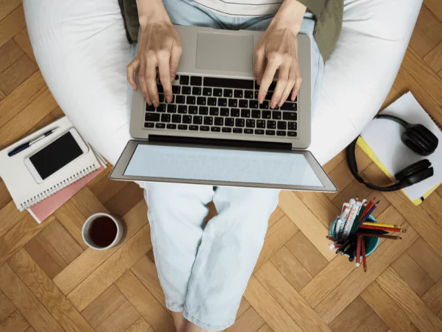 woman working on laptop sat on a bean bag