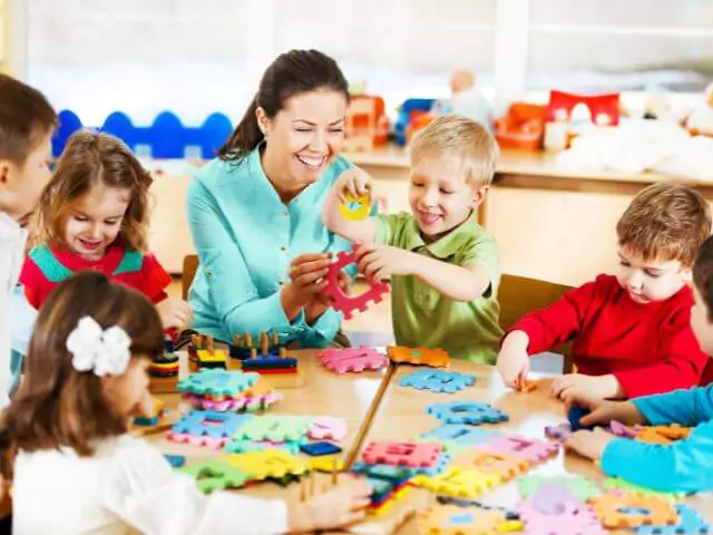 teaching assistant playing with children